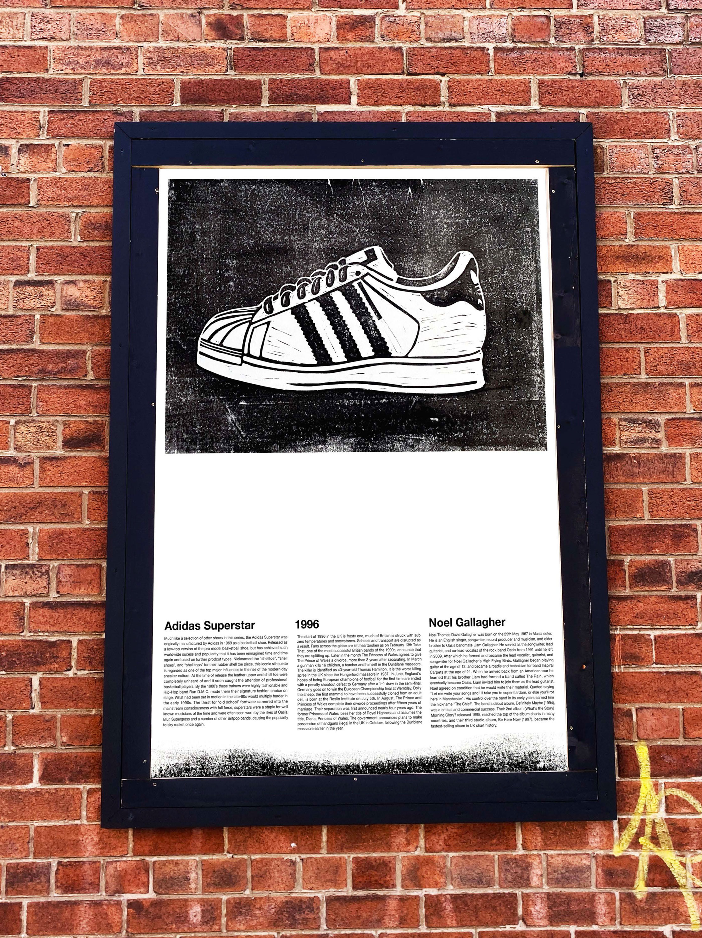 Mock-up photograph, poster in situe, featuring linocut print of Adidias Superstars trainers