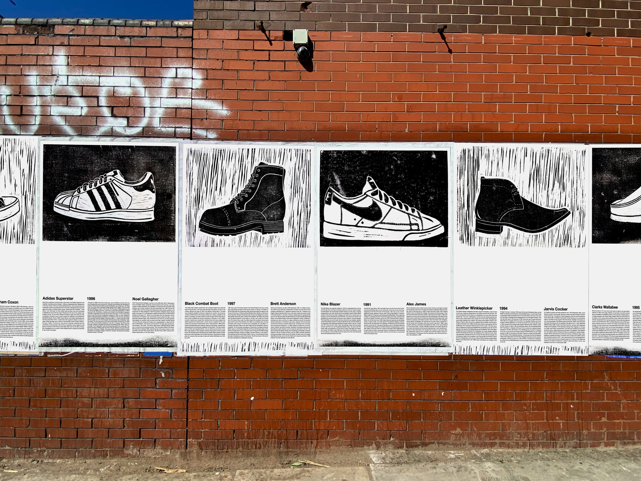Mock-up photograph, series of poster in situ, featuring linocut print of trainers
