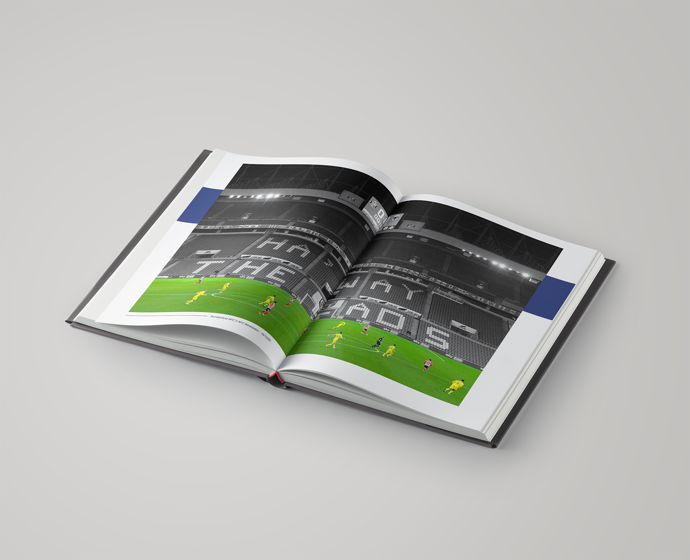 Mock-up of a publication spread showing a photograph of an empty football stadium
